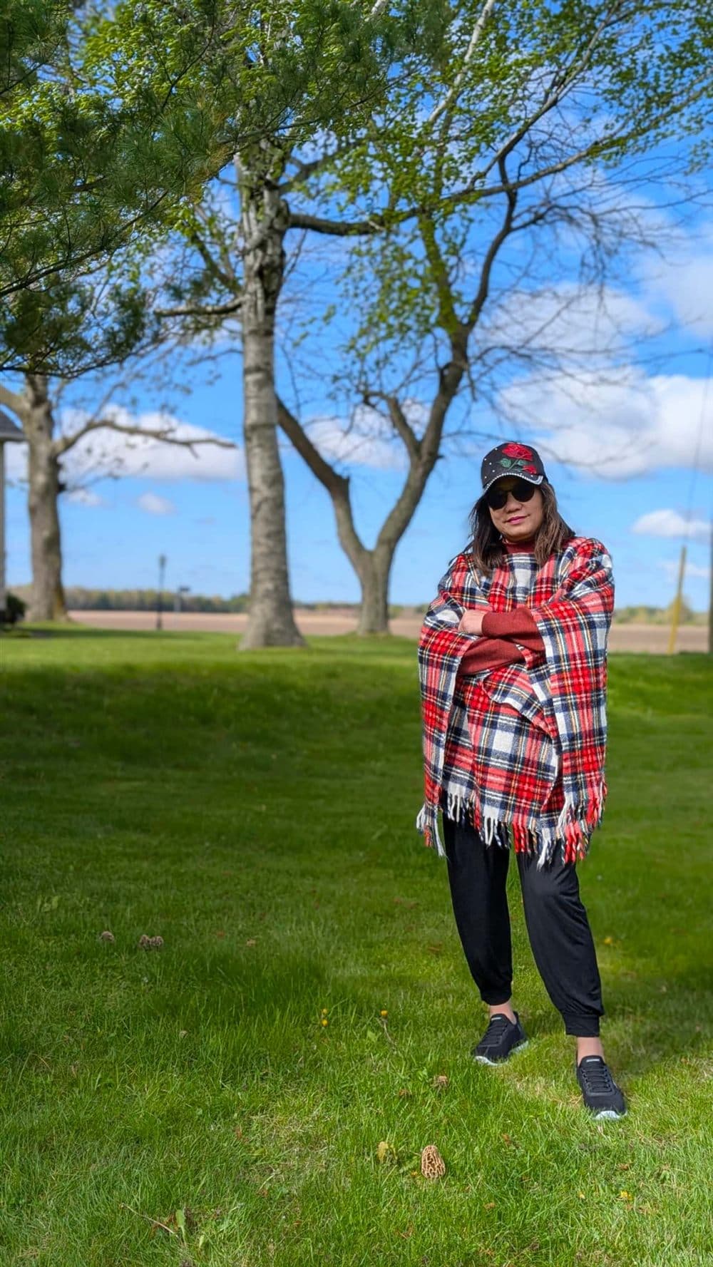 Ping last spring — rose cap, red plaid wrap, in a field