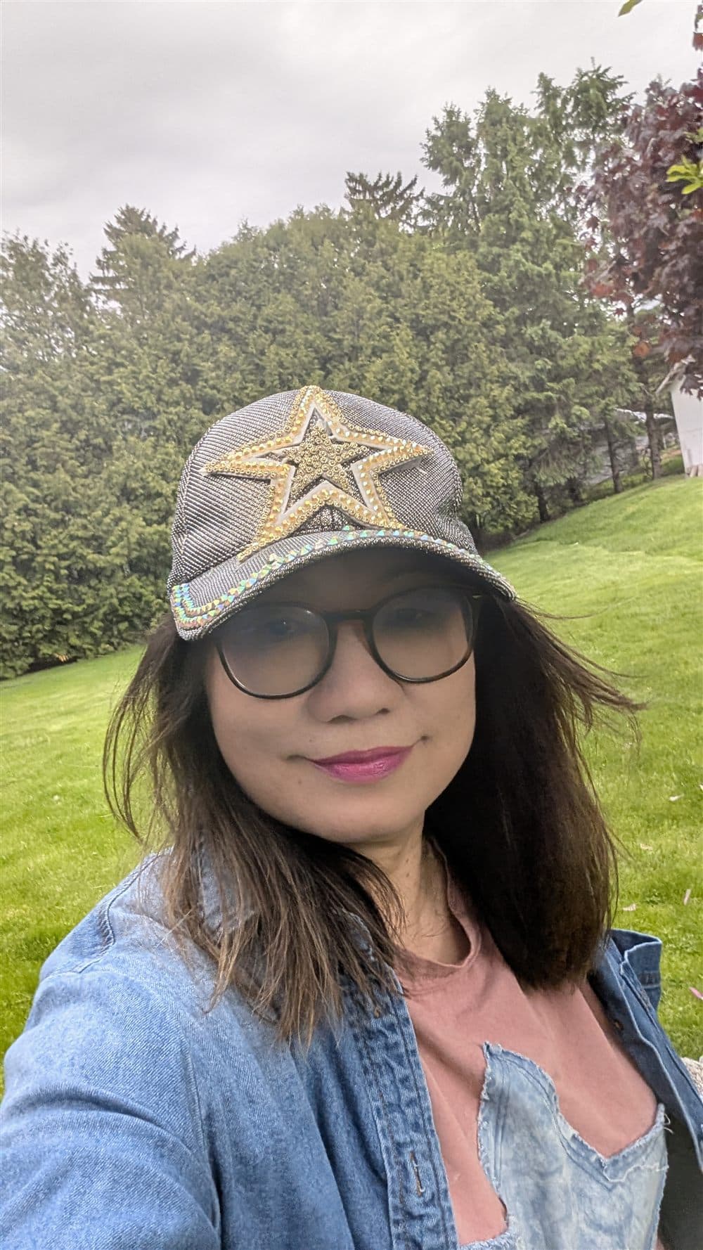 Ping today — star cap and round glasses, on the lawn