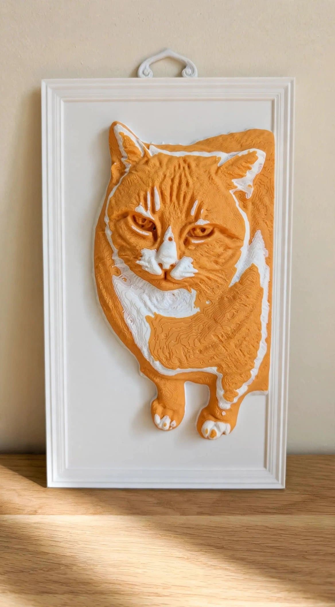 Fatcat — a hand-painted orange-and-white 3D relief portrait in a white frame